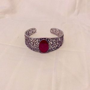 Women bracelet with a a reddish stone